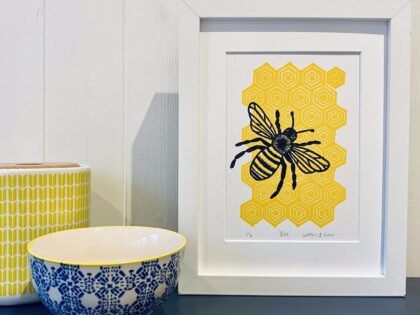 Bee framed linocut print on display