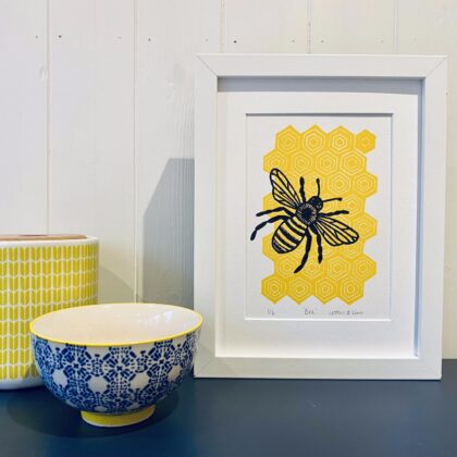 Bee framed linocut print on display