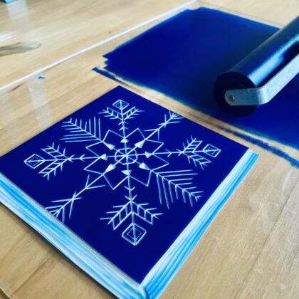 Blue inked snowflake lino block Blue inked snowflake lino block
