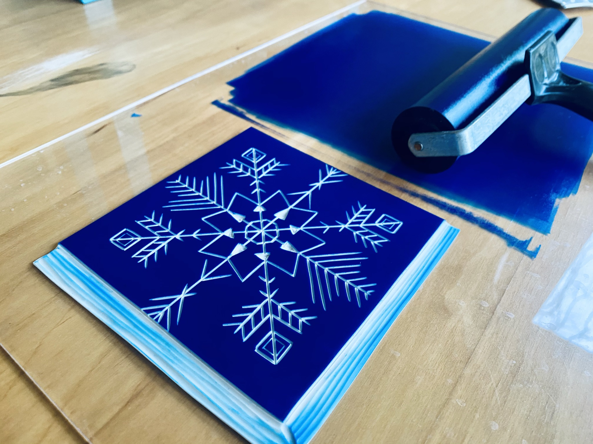 Blue inked snowflake lino block Blue inked snowflake lino block