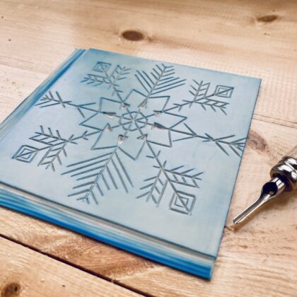 Carved lino snowflake design Carved lino snowflake design
