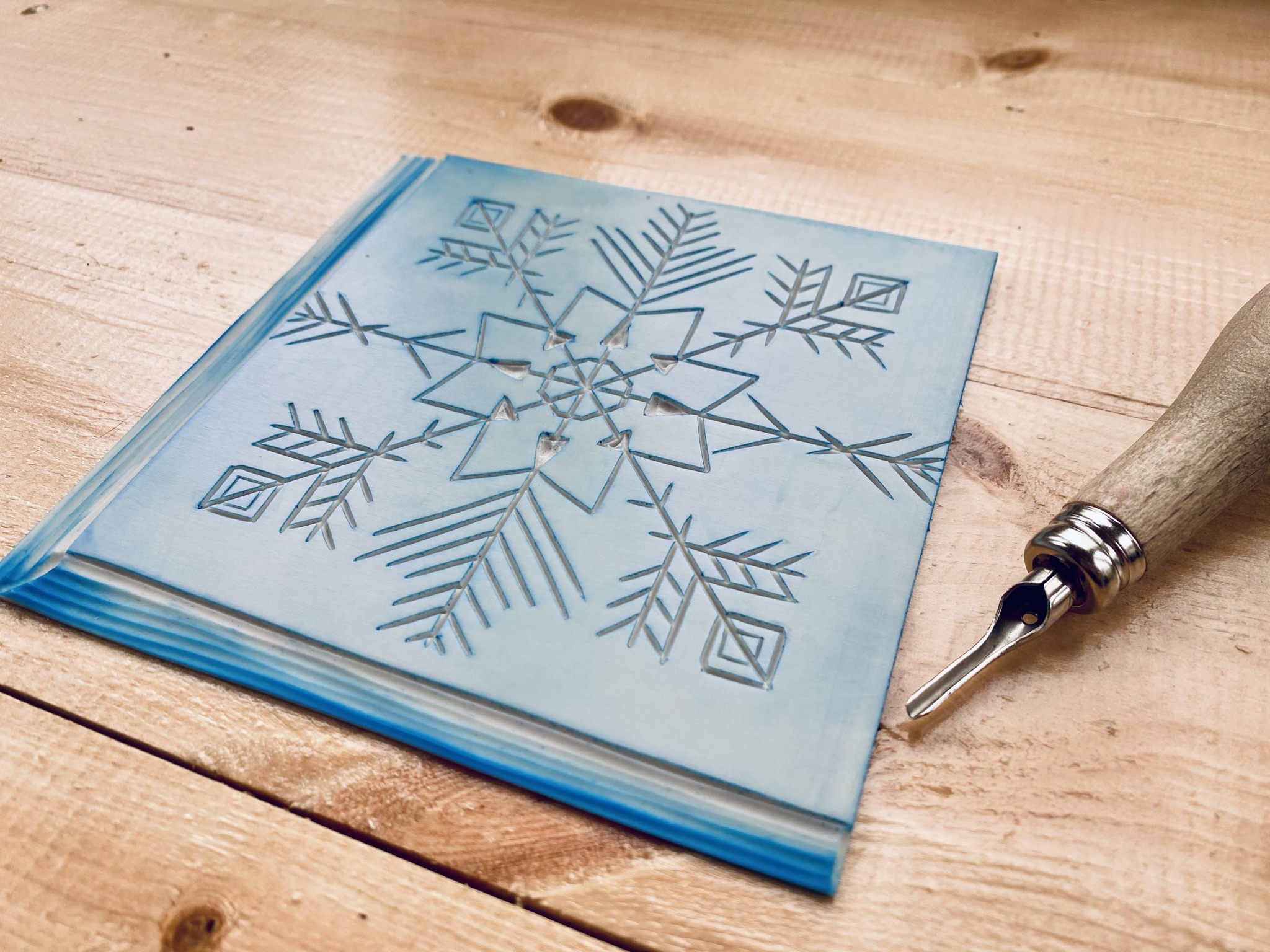 Carved lino snowflake design Carved lino snowflake design