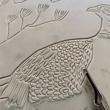 Close up carving pheasant in autumn lino block