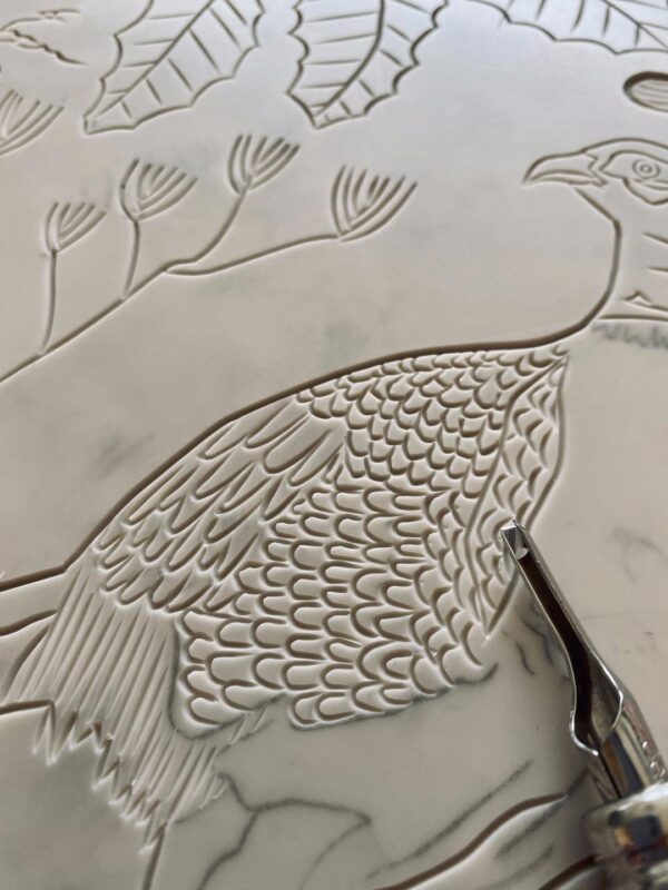 Close up carving pheasant in autumn lino block