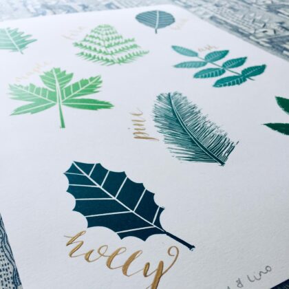 Detail gold calligraphy holly large leaves linocut print