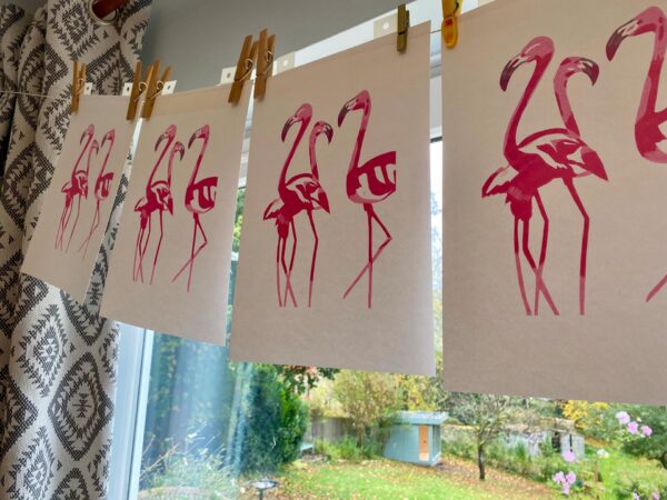 Flamingos reduction linocut print colour layers drying