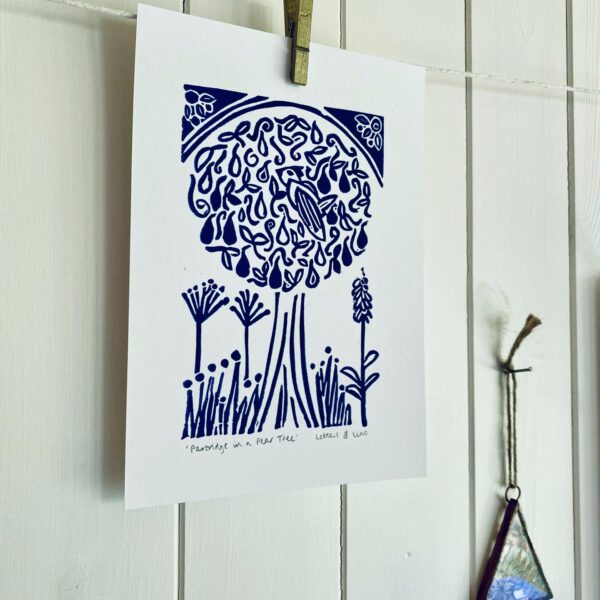 Partridge in a pear tree a5 blue lino cut print hanging