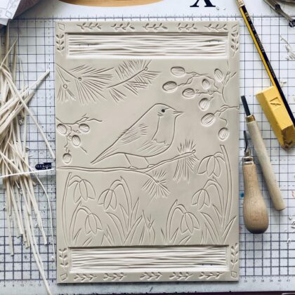Robin in winter carved lino block